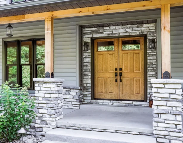 Dark oak French entry doors under a covered porch