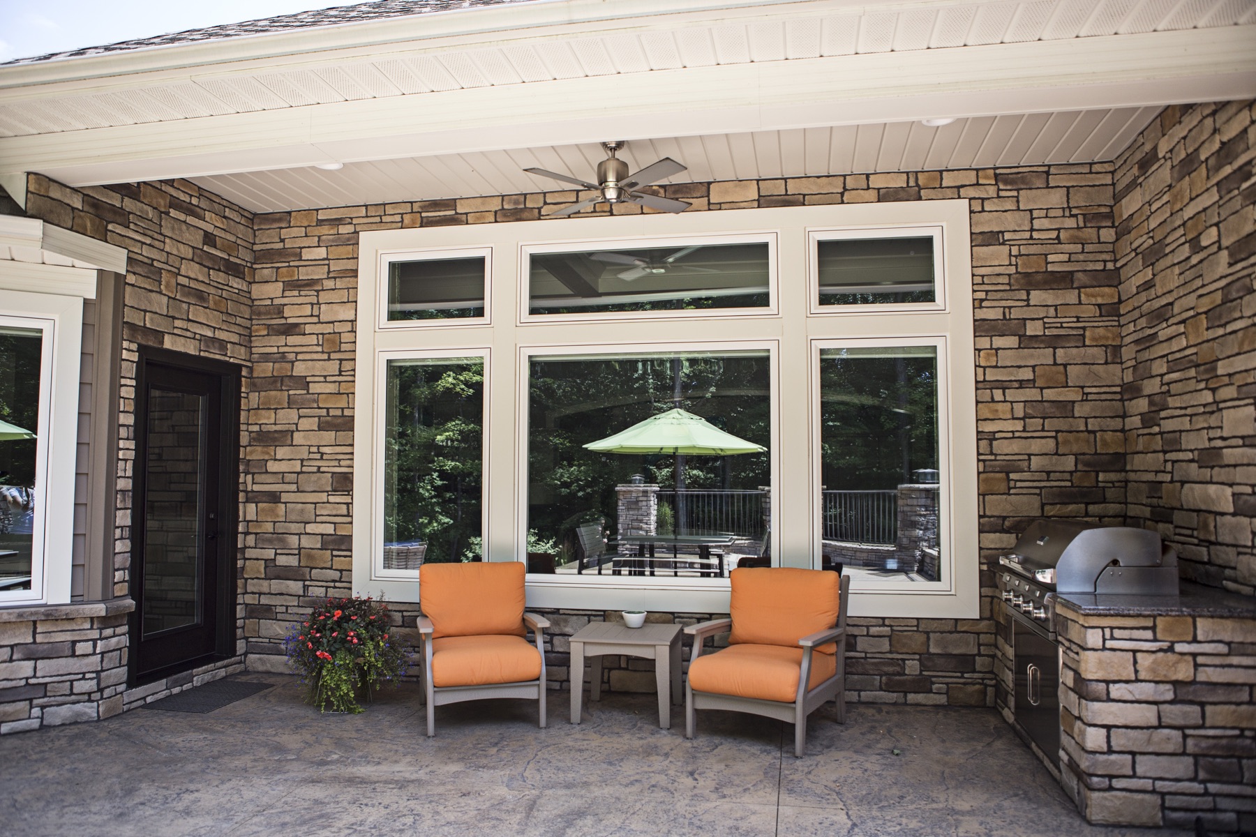 Large exterior picture and casement window wall on covered patio